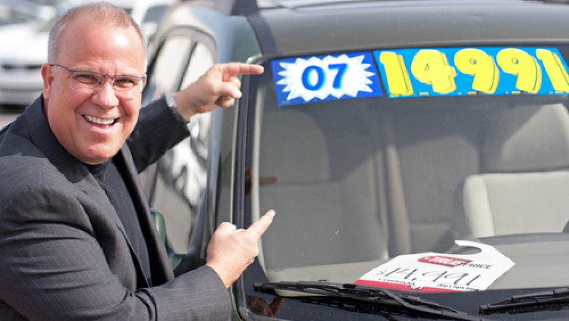 Car,Salesman,On,Lot,With,Price,Sticker,On,Cae,Selling