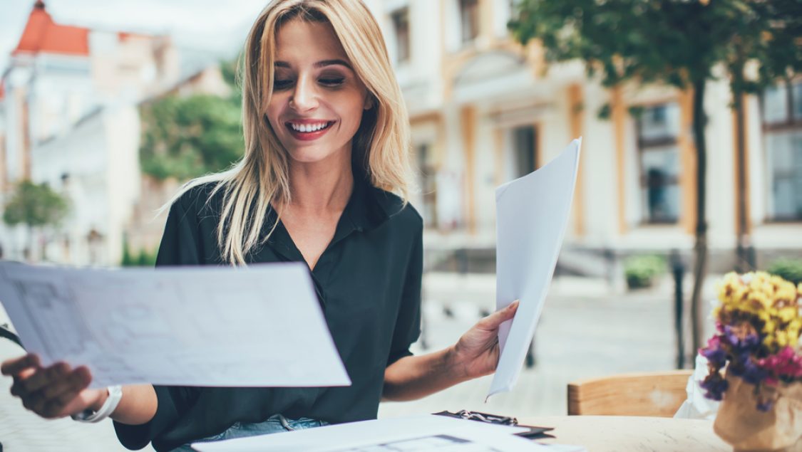 Happy,Female,In,Casual,Clothing,Analyzing,Information,From,Papers,Sitting